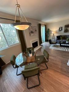 a living room with a glass table and chairs at Beverly Hills Midle City 1 br Apt with Parking 202 in Los Angeles