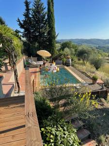 a swimming pool with people sitting in it at Casa Panzano Tuscany in Panzano
