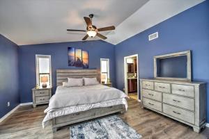 a blue bedroom with a bed and a ceiling fan at Cape Coral Paradise 4 BD 12sleeps, W/heated pool in Cape Coral +19 photos
