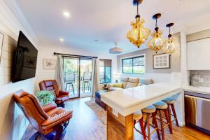 a kitchen and living room with a table and chairs at Carolina Beach Club 125 in Hilton Head Island