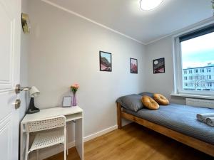 a bedroom with a bed and a window at MMRent Moonlight Room in Gdańsk