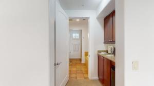 a hallway of a kitchen with a door open at LV022 Centrally Located Downstairs LV Studio in La Quinta +3 photos