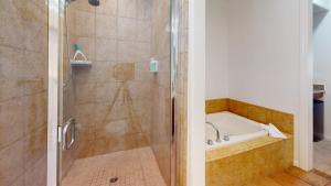 a bathroom with a shower and a bath tub at LV022 Centrally Located Downstairs LV Studio in La Quinta
