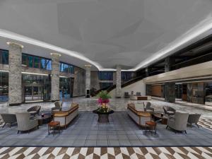 a lobby with chairs and tables in a building at Hilton Shanghai Hongqiao in Shanghai