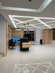an office with a desk and a chair in a room at قمم بارك النماص 8 Qimam Park Hotel in Al Namas