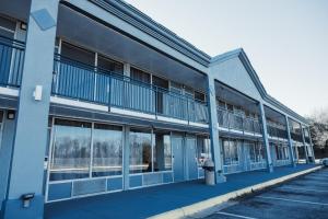 a blue building with windows and a parking lot at Reidsville Inn & Suites in Reidsville