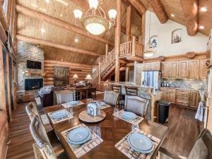 a dining room with a table and chairs at Spectacular Custom Log Cabin with Hot Tub, Epic Views, Fireplace - Moose Tracks Cabin in Fairplay