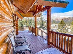 a porch of a cabin with two benches on it at Spectacular Custom Log Cabin with Hot Tub, Epic Views, Fireplace - Moose Tracks Cabin in Fairplay