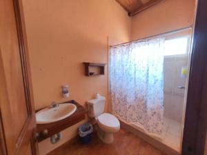 a bathroom with a sink and a toilet and a shower at Habitacion cerca del lago in Flores