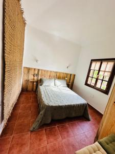 a bedroom with a bed in the corner of a room at Casa La Pepita in Caleta De Fuste