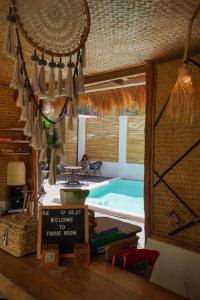 a swimming pool in a room with a table and chairs at Focus Rooms in El Nido +62 photos