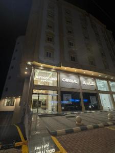 a large building with a store in front of it at قمم بارك النماص 8 Qimam Park Hotel in Al Namas