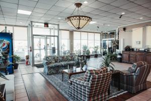 a living room with couches and a table at Reidsville Inn & Suites in Reidsville