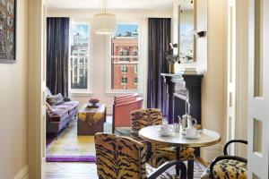 - un salon avec une table, des chaises et une cheminée dans l'établissement The Hotel Chelsea, à New York