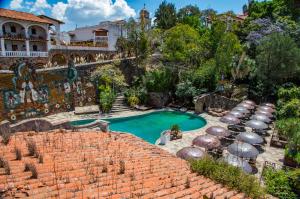 an overhead view of a swimming pool with umbrellas at Casona Colonial de la Misión in Taxco de Alarcón +27 photos