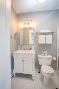 a bathroom with a white toilet and a sink at 2W Lake in Skaneateles