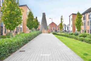 a brick walkway in a city with buildings at Kiln Side by Truestays - 3 Bedroom House in Etruria