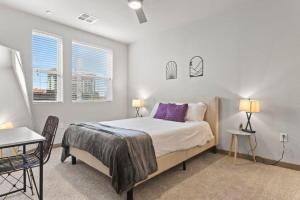 a bedroom with a bed and a table and chairs at 3BR Cozysuites RORO Pool, Pets, Parking 7&13 in Phoenix