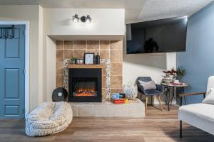 a living room with a fireplace and a blue door at The Bohemian in Red Deer