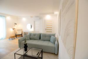 a living room with a couch and a table at Charming Apartment in Heart of Vienna l JOS20 in Vienna