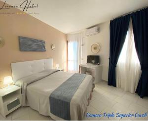 Ein Bett oder Betten in einem Zimmer der Unterkunft Hotel Lorenza B&B e Mini Suite