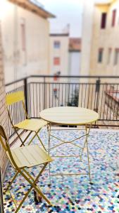 a table and two chairs on a balcony at 4Th Floor Caserta in Caserta