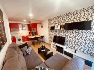 a living room with a couch and a tv at O Fogar do Mar in Combarro +20 photos