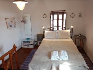 a bedroom with a large bed with two white pillows at Kissamitakis Guesthouse in Monemvasia