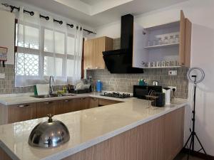a kitchen with a sink and a counter top at Almasi beach house in Mtwapa