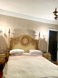 a bedroom with a gold bed with two pillows at Lovely apartment in Alexandria