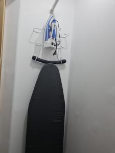 a helmet hanging on a wall next to a black surfboard at Sky Beach Hotel in Hopewell