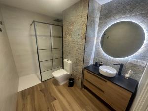 a bathroom with a sink and a mirror at Beach Apartments Valencia in Valencia