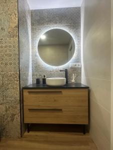 a bathroom with a sink and a mirror at Beach Apartments Valencia in Valencia