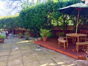 a patio with a table and chairs and an umbrella at studio flat near NEC, Solihull & Airport. Short & Long stay Contractors HS2, NHS in Solihull