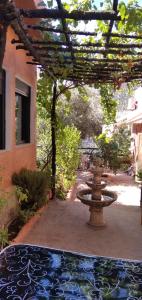 a fountain in the middle of a courtyard with a building at DAR LAMRABET in Bine el Ouidane