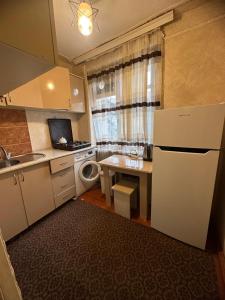 uma pequena cozinha com um frigorífico e um lavatório em Samir Gues Hause em Ganja