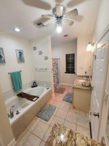 a large bathroom with a tub and a sink at Home lux in Louisiana in Laplace