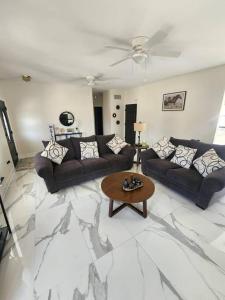 a living room with two couches and a coffee table at Home lux in Louisiana in Laplace