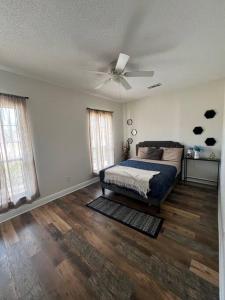 a bedroom with a bed and a ceiling fan at Home lux in Louisiana in Laplace