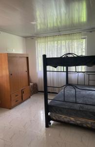 a bedroom with a bunk bed and a dresser at Casa Campestre Finca Villa Amparo in Silvania