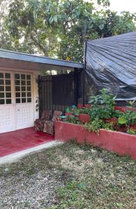 a house with a red porch and a garage at Casa Campestre Finca Villa Amparo in Silvania