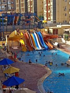 a group of people in a pool at a water park at استوديو للعائلات داخل قرية Retal View north coast in El Alamein