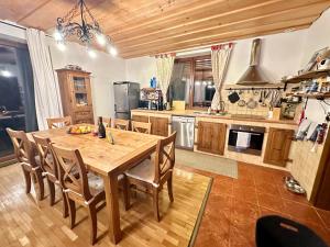 a large kitchen with a wooden table and chairs at Chata Hana Donovaly in Donovaly