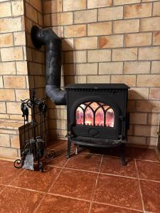 a fireplace in a brick wall with a stove at Chata Hana Donovaly in Donovaly