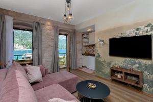 a living room with a couch and a flat screen tv at Apartments by the sea Igrane, Makarska - 20373 in Igrane