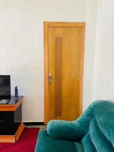 a room with a door and a couch and a television at Luxury Studio , heart of Hassan in Rabat