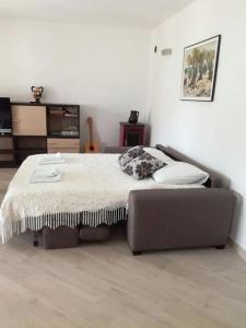 a bedroom with a bed and a couch in it at Apartments by the sea Pag - 21962 in Pag