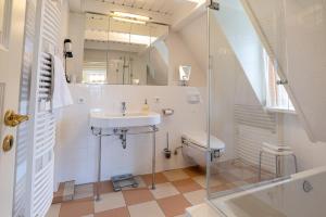 a bathroom with a sink and a toilet at Ferienhaus Friesenrose in Nieblum +20 photos