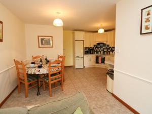 a kitchen and dining room with a table and chairs at Stags Cottage in North Molton