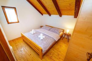 a bedroom with a bed with two candles on it at Family friendly house with a swimming pool Rudopolje Bruvanjsko, Zagora - 21427 in Gračac